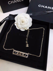 CHANEL 26S CHANEL CC LOGO CRYSTAL TRIM BAR PENDANT NECKLACE WITH BLACK LEATHER IN GOLD METAL 633315