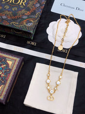 CD 26S CD LOGO CRYSTAL STATION NECKLACE IN GOLD TONE METAL WITH WHITE CRYSTAL 631006