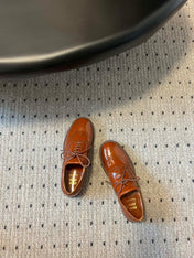 MIUMIU 26S LACE-UP BROGUE LOAFERS IN RUST ORANGE PATENT CALFSKIN