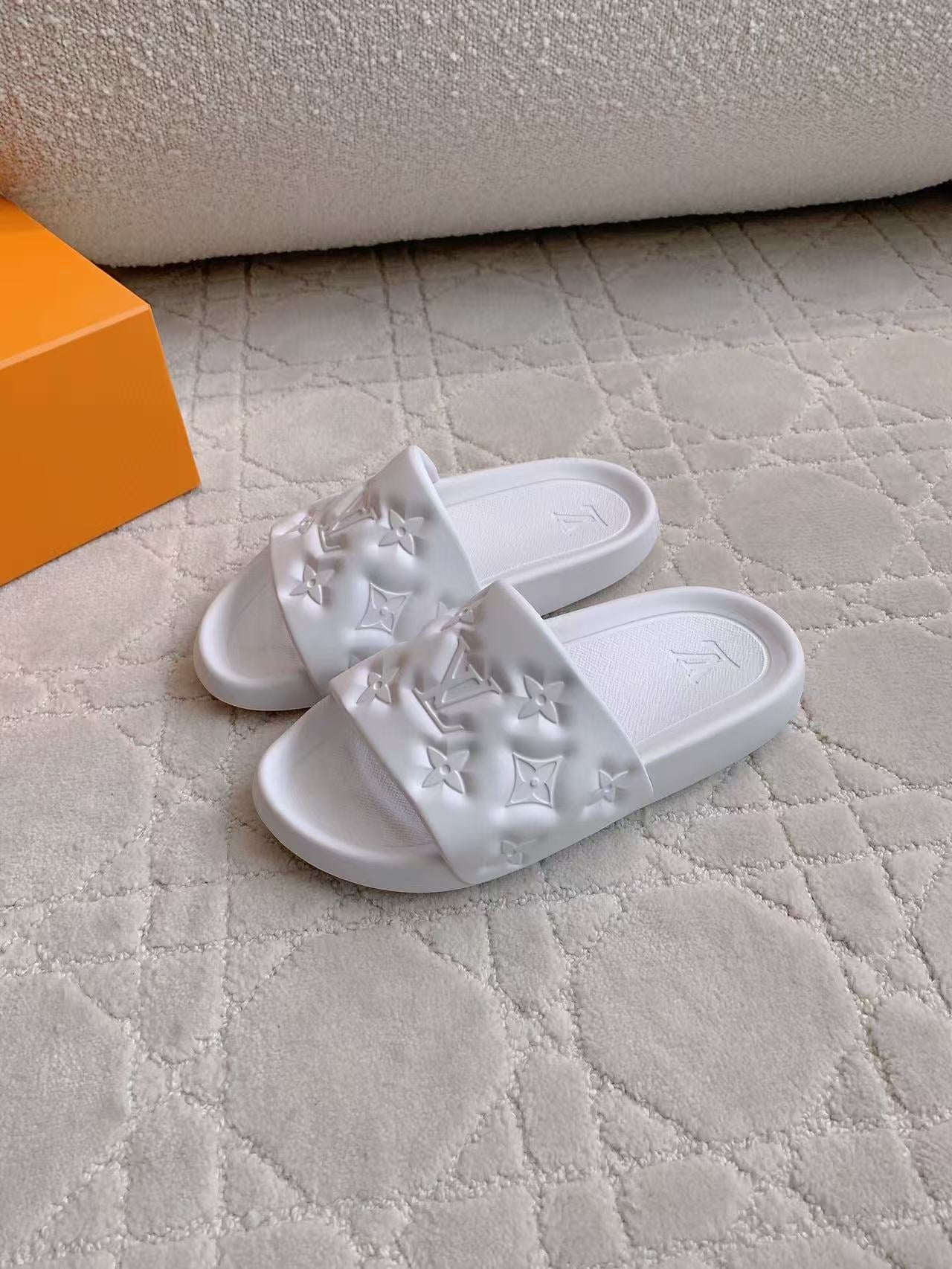 LV EMBOSSED POOL PILLOW SANDALS IN WHITE RUBBER
