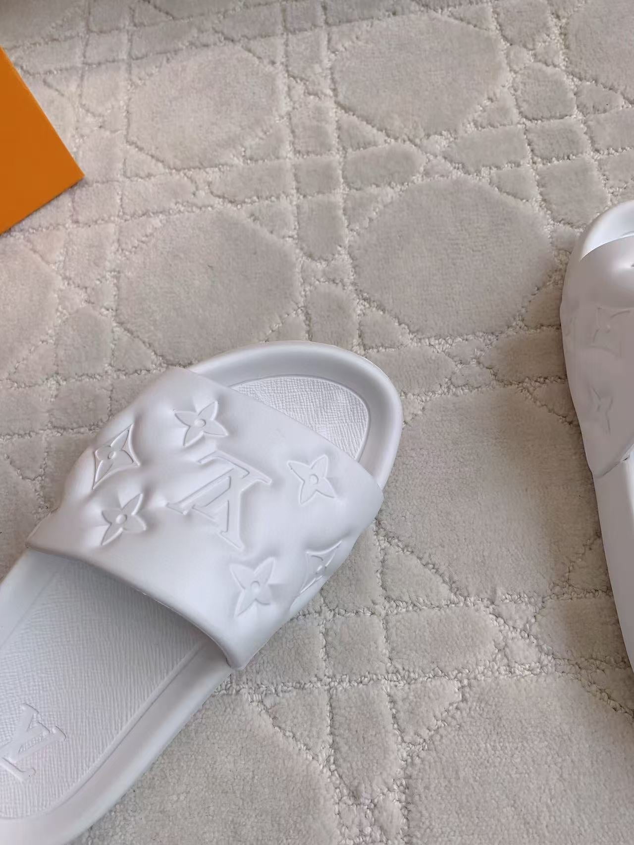 LV EMBOSSED POOL PILLOW SANDALS IN WHITE RUBBER
