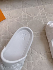LV EMBOSSED POOL PILLOW SANDALS IN WHITE RUBBER