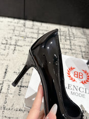 POINTED HIGH PUMPS IN BLACK PATENT CALFSKIN WITH CRYSTAL BUCKLE