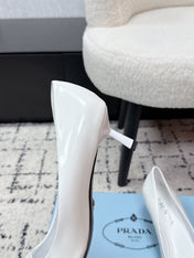 PRADA 26S POINTED-TOE HIGH HEELS 60MM IN WHITE PATENT CALFSKIN WITH LOGO