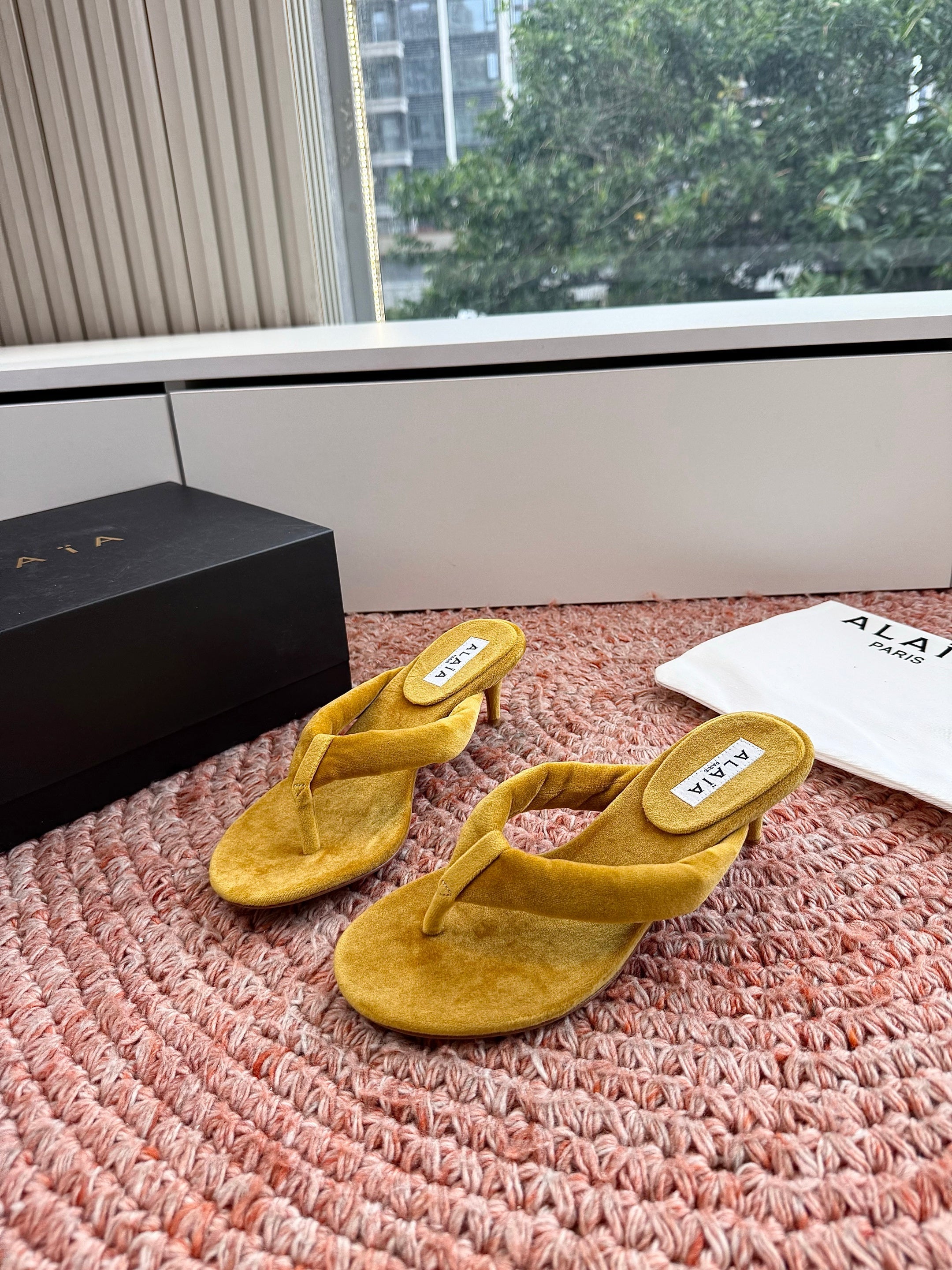 ALAIA 26S HEELED THONG SANDALS IN MUSTARD YELLOW VELVET