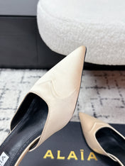 ALAIA 26S HEELED MULES 65 MM IN IVORY BEIGE SATIN