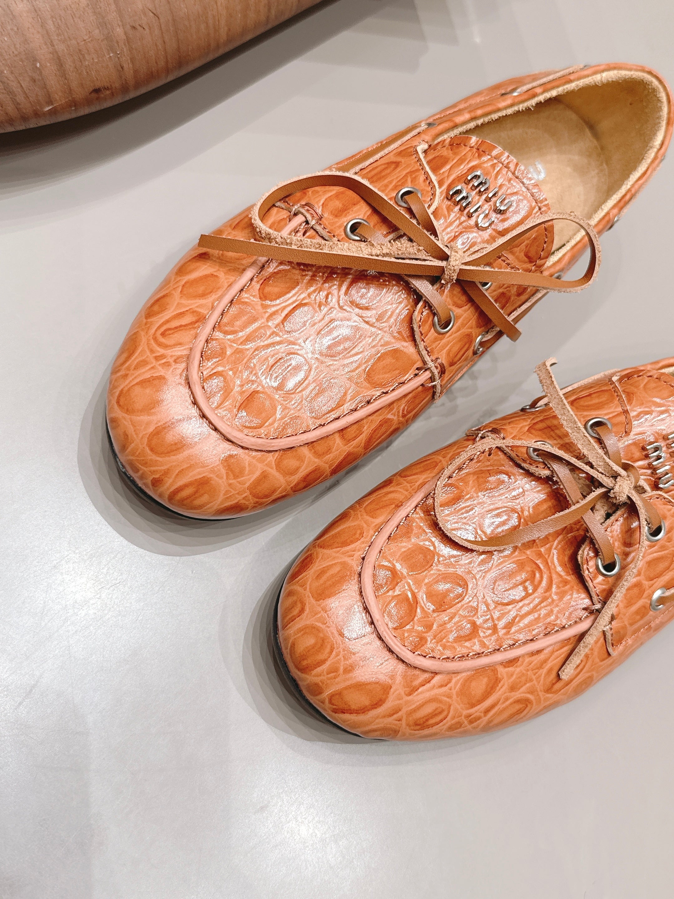 MIUMIU 26S BOAT SHOES IN ORANGE BROWN EMBOSSED CALFSKIN