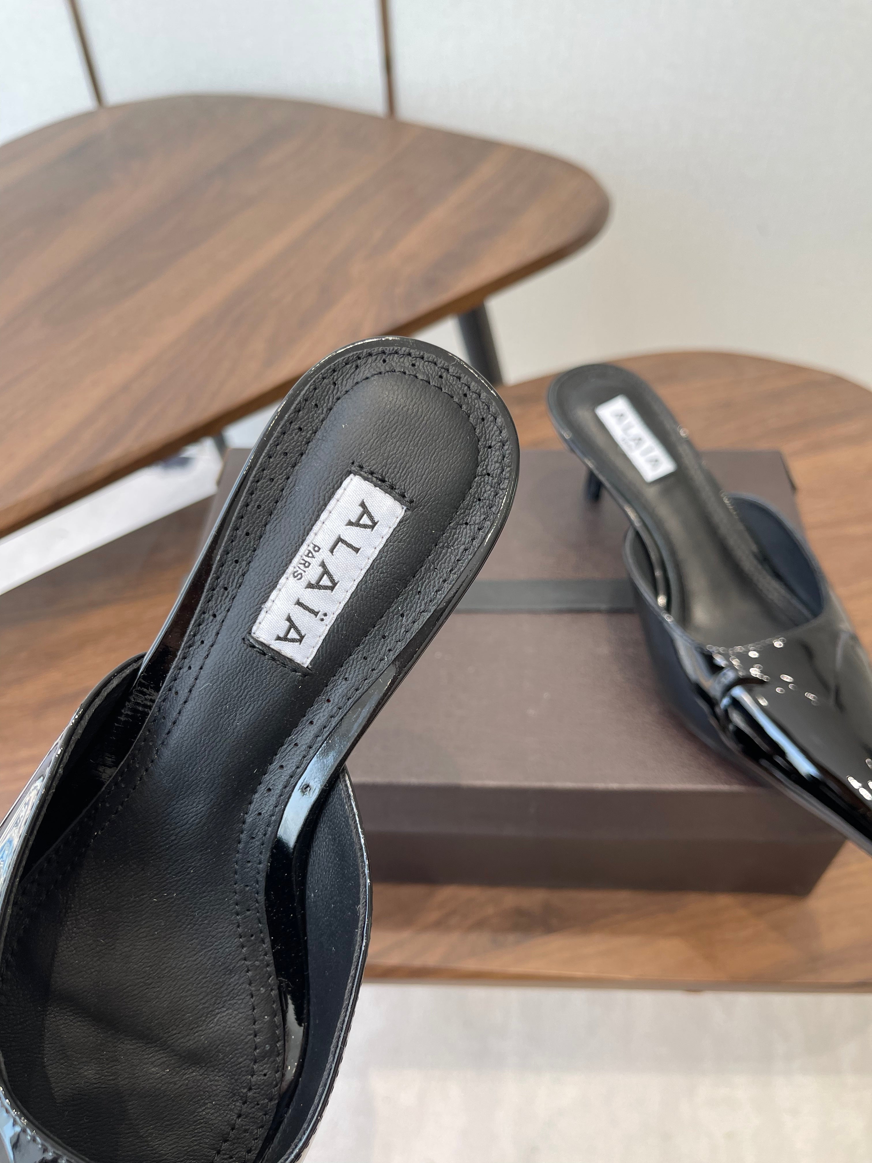 ALAIA 26S HEELED MULES 50 MM IN BLACK GLOSSY CALFSKIN