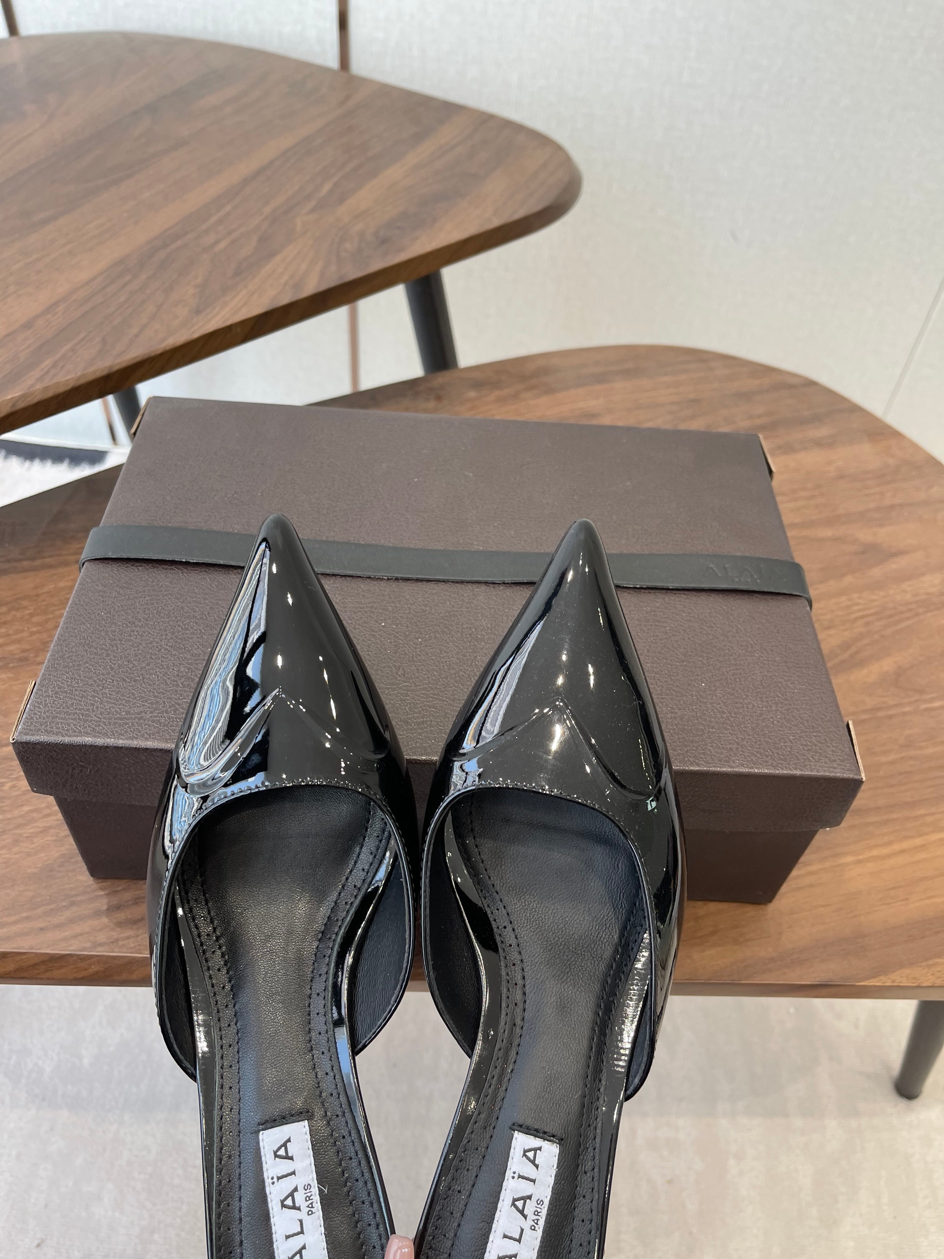 ALAIA 26S HEELED MULES 50 MM IN BLACK GLOSSY CALFSKIN