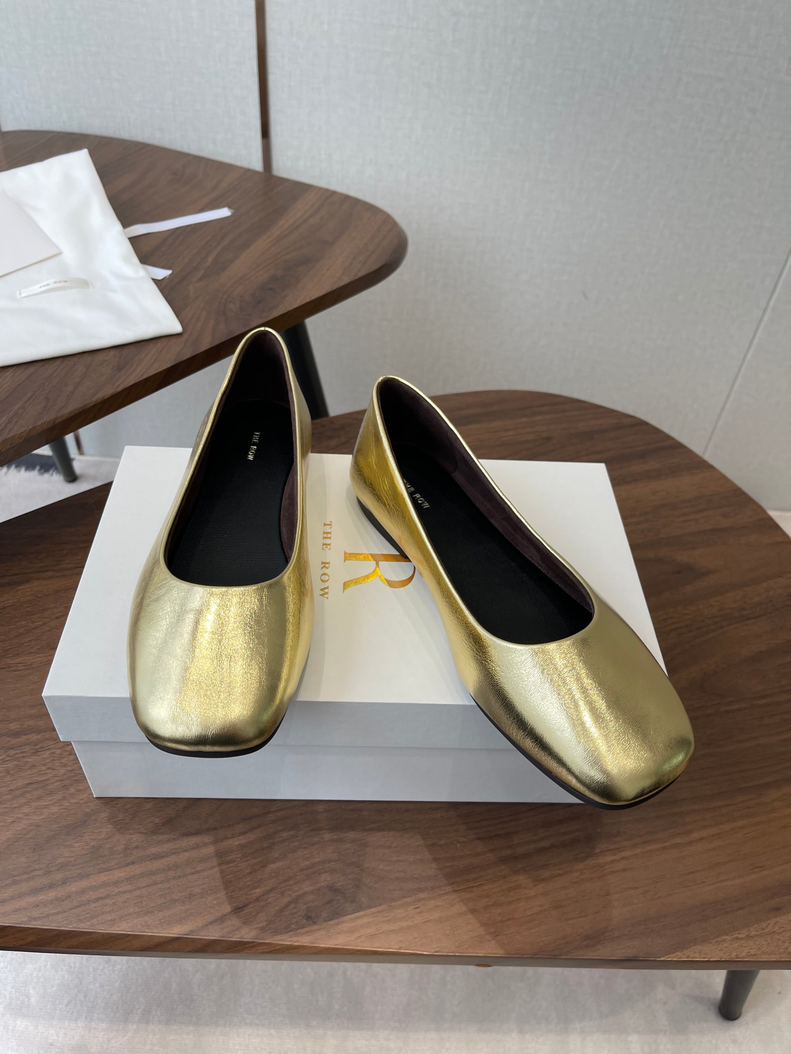 THE ROW 26S FLATS IN GOLD CALFSKIN