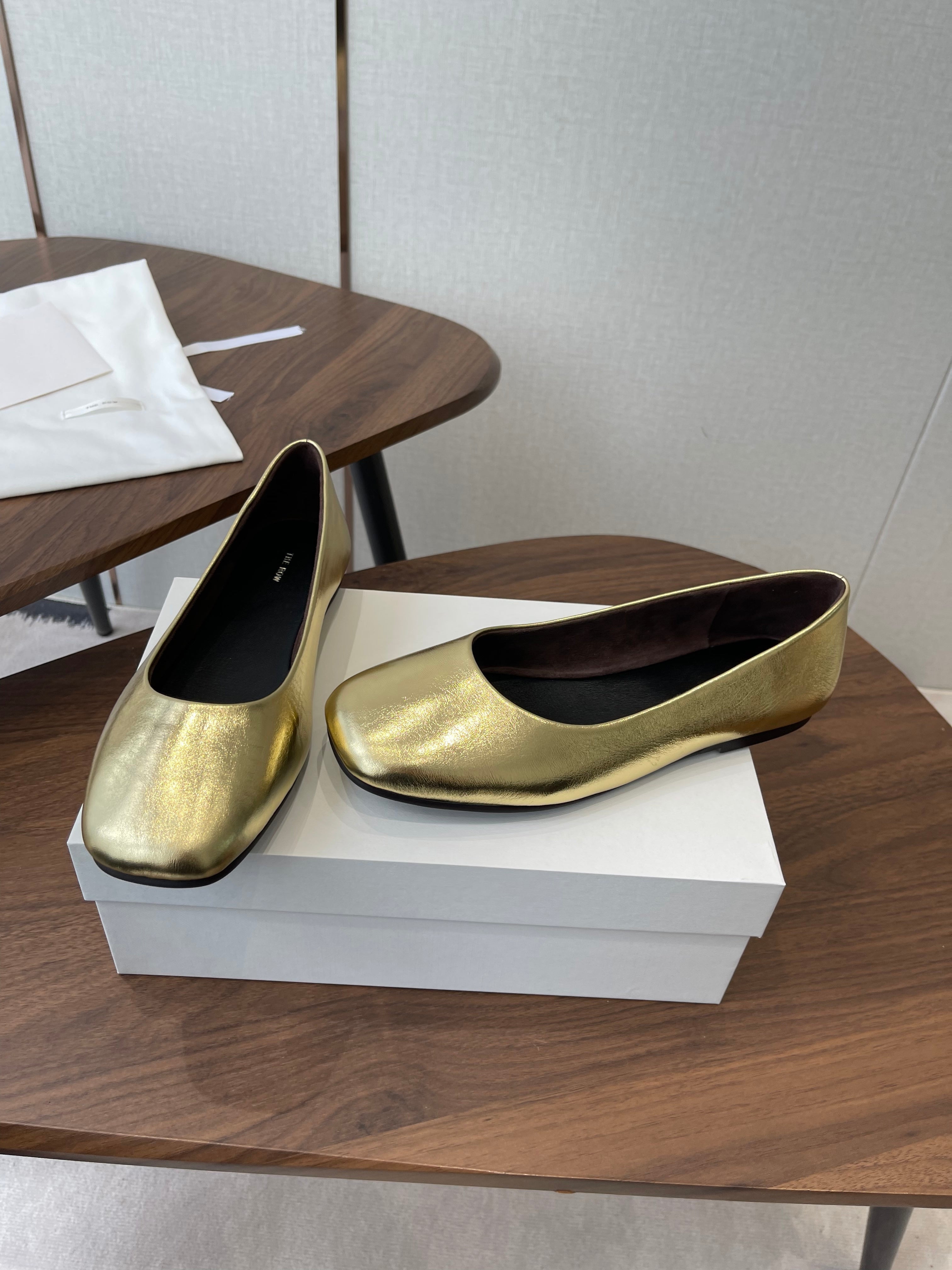 THE ROW 26S FLATS IN GOLD CALFSKIN