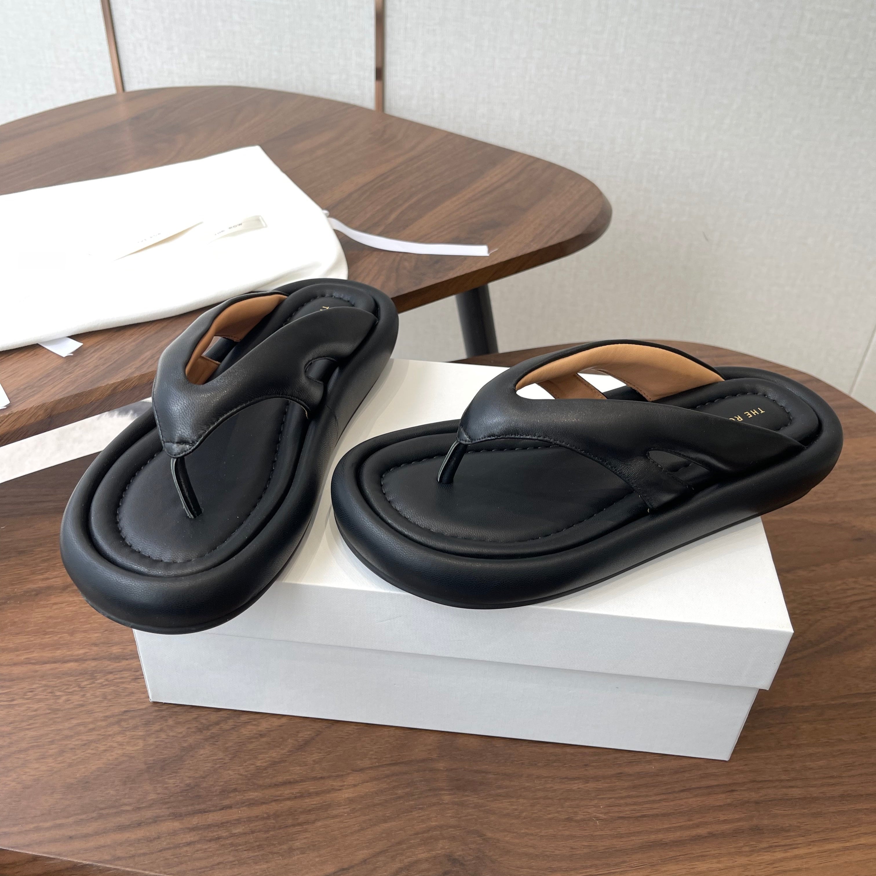 THE ROW 26S PUFFED THONG SANDALS IN BLACK CALFSKIN