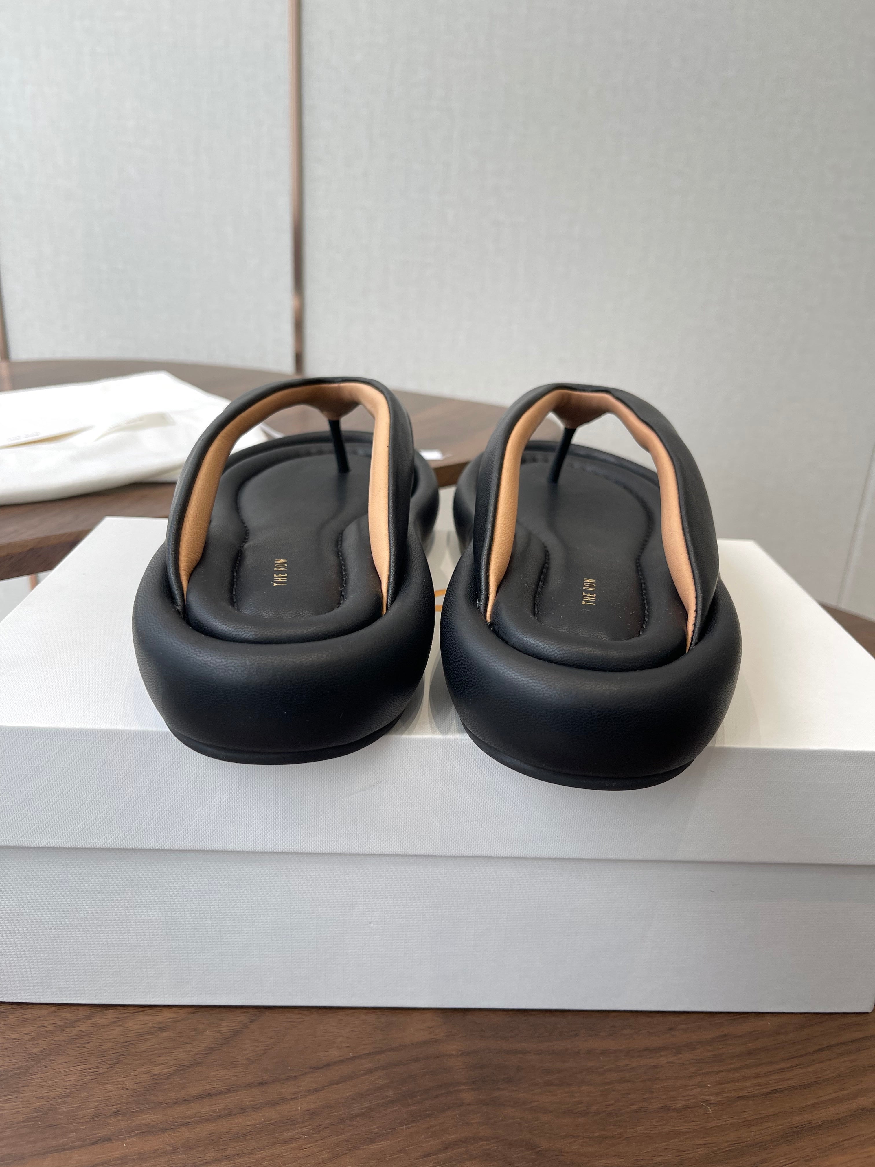 THE ROW 26S PUFFED THONG SANDALS IN BLACK CALFSKIN