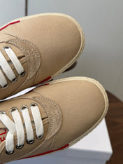 CELINE 26S TRIOMPHE LOW TOP SNEAKERS IN BEIGE CANVAS RED TRIM