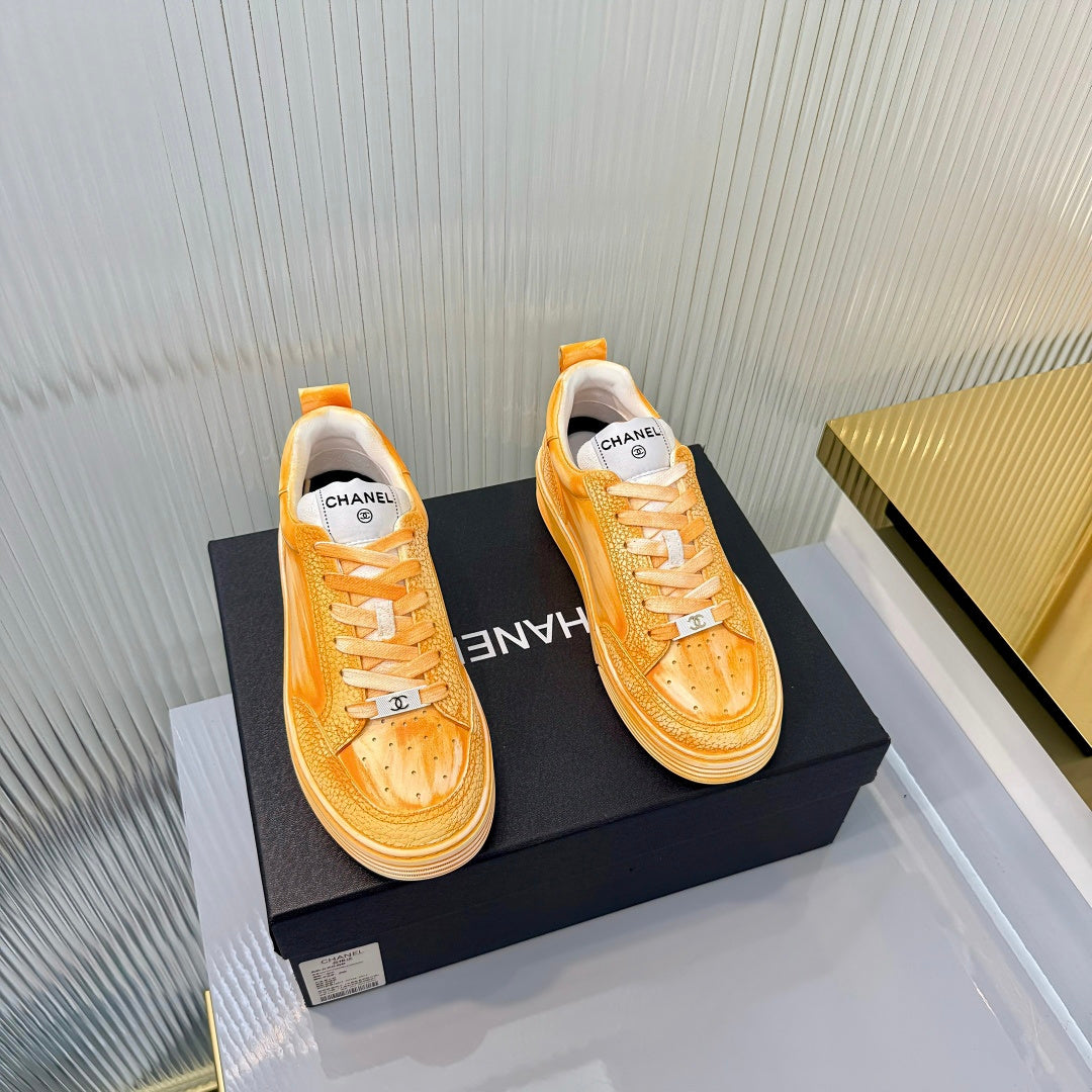 CHANEL 26S LOW-TOP SNEAKERS IN GOLDEN ORANGE CALFSKIN
