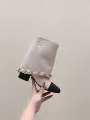 CHANEL 25S CALF-LENGTH BOOTS 45MM IN WHITE AND BLACK CALFSKIN GOLD HARDWARE