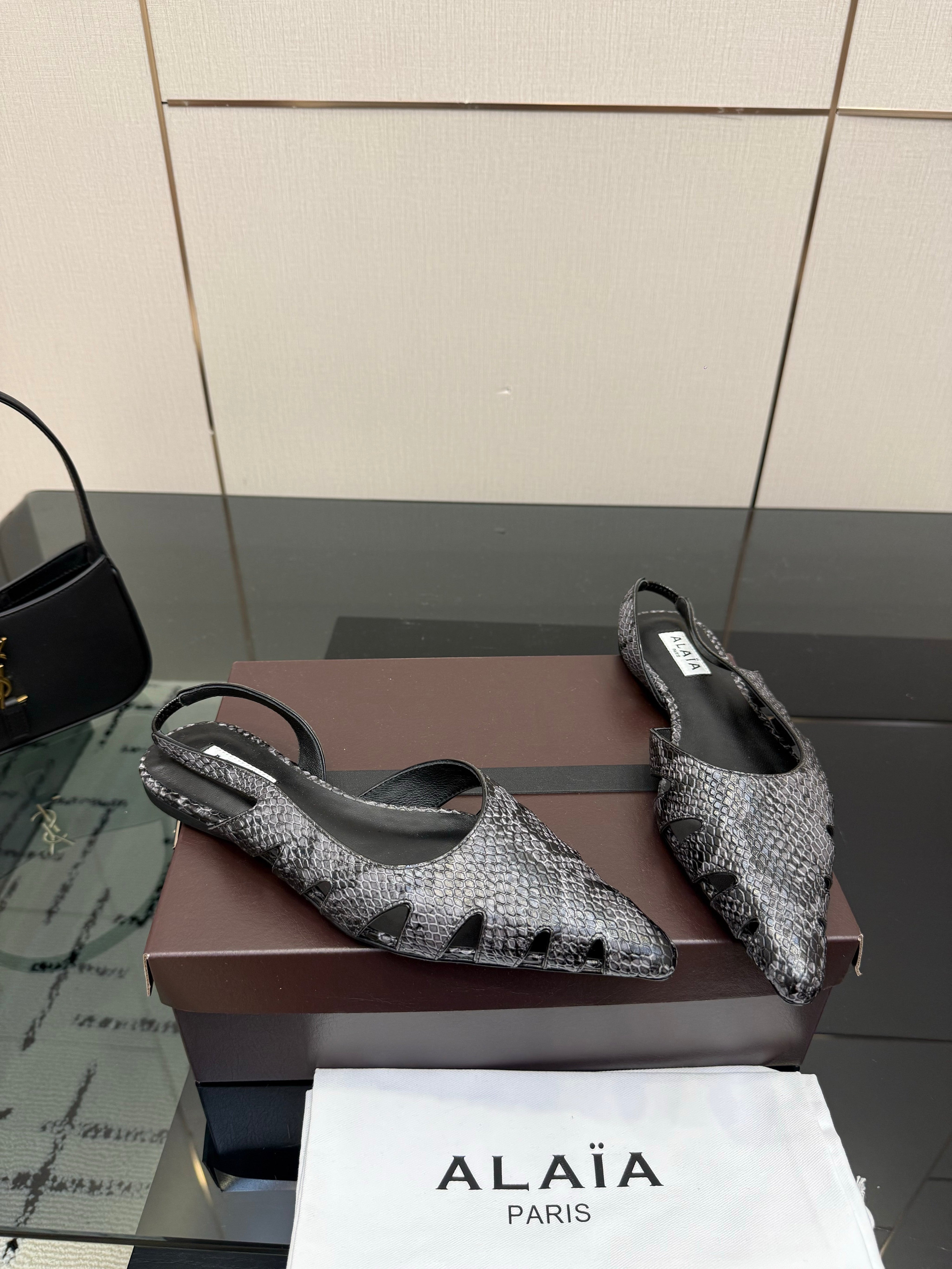 ALAIA 26S CUT-OUT SLINGBACK FLATS IN BLACK PYTHON-EMBOSSED LEATHER