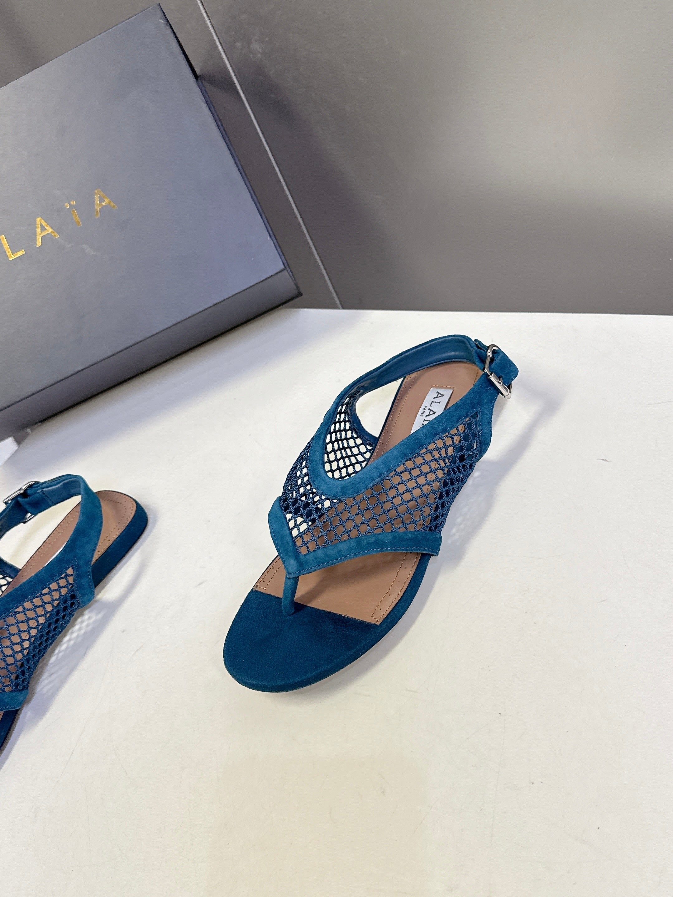 ALAIA 26S FLAT MESH THONG SANDALS IN PETROL BLUE SUEDE
