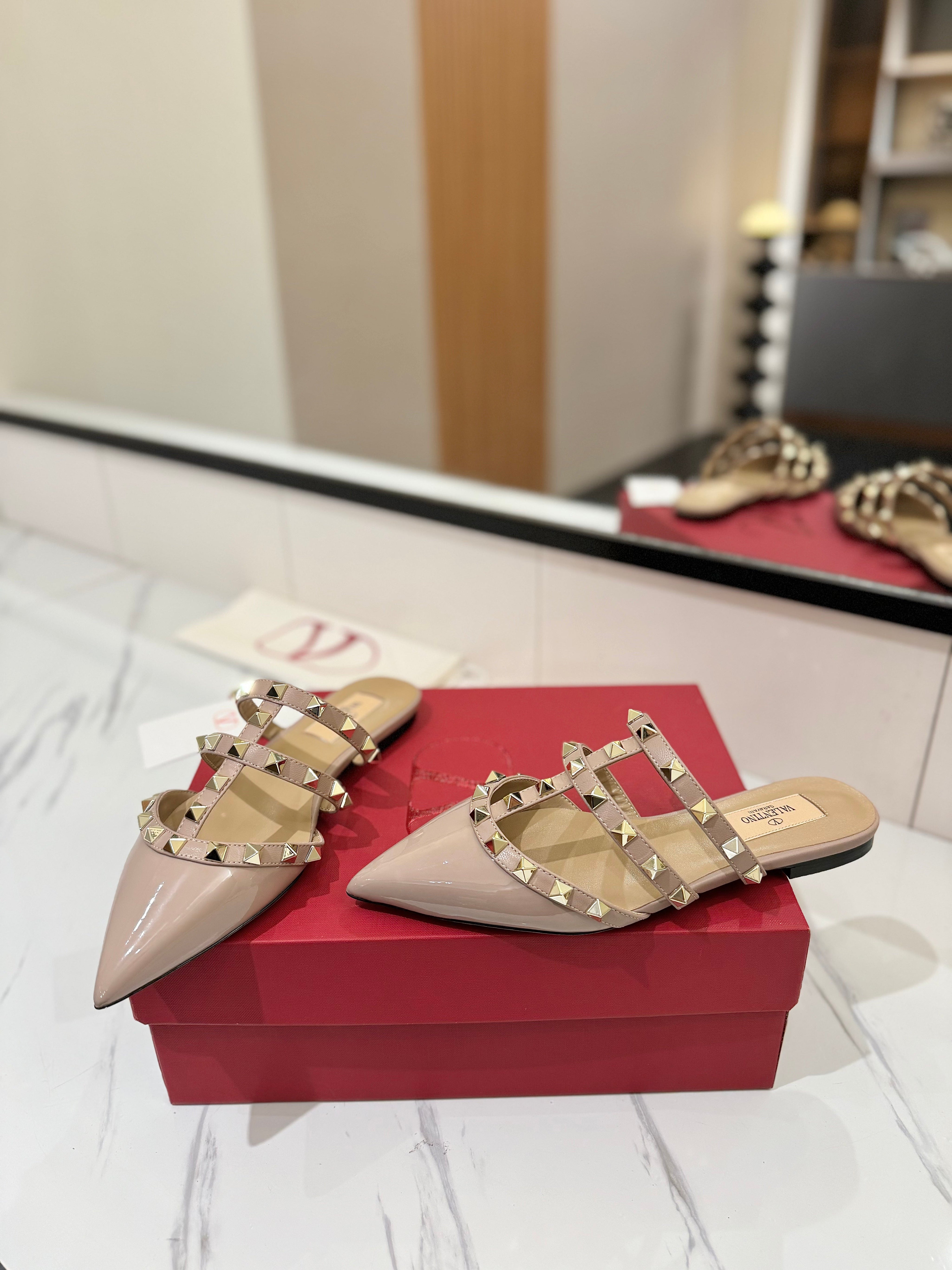 VALENTINO 26S STUDDED FLAT MULES IN NUDE PATENT CALFSKIN