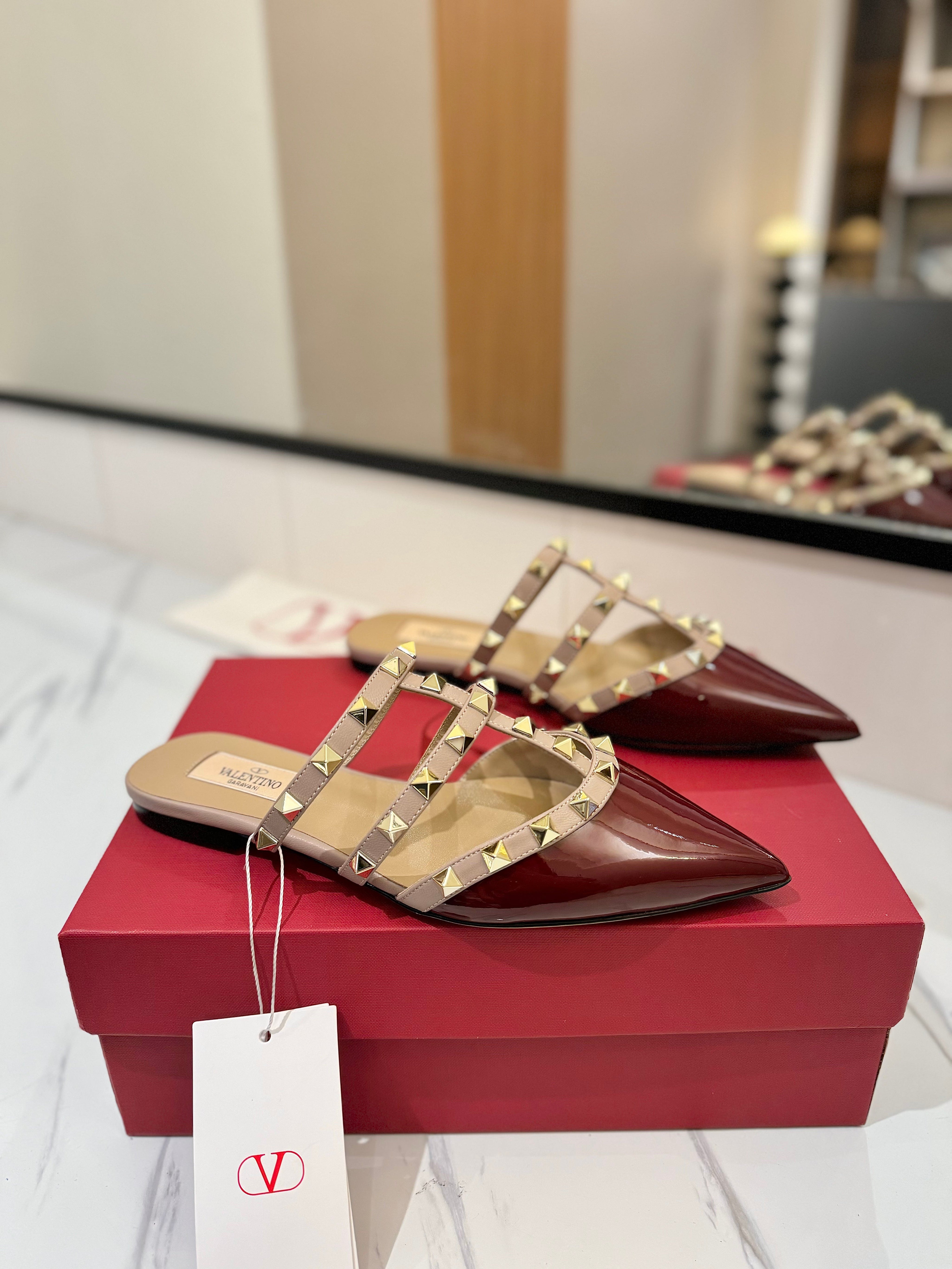 VALENTINO 26S STUDDED FLAT MULES IN DARK RED PATENT CALFSKIN