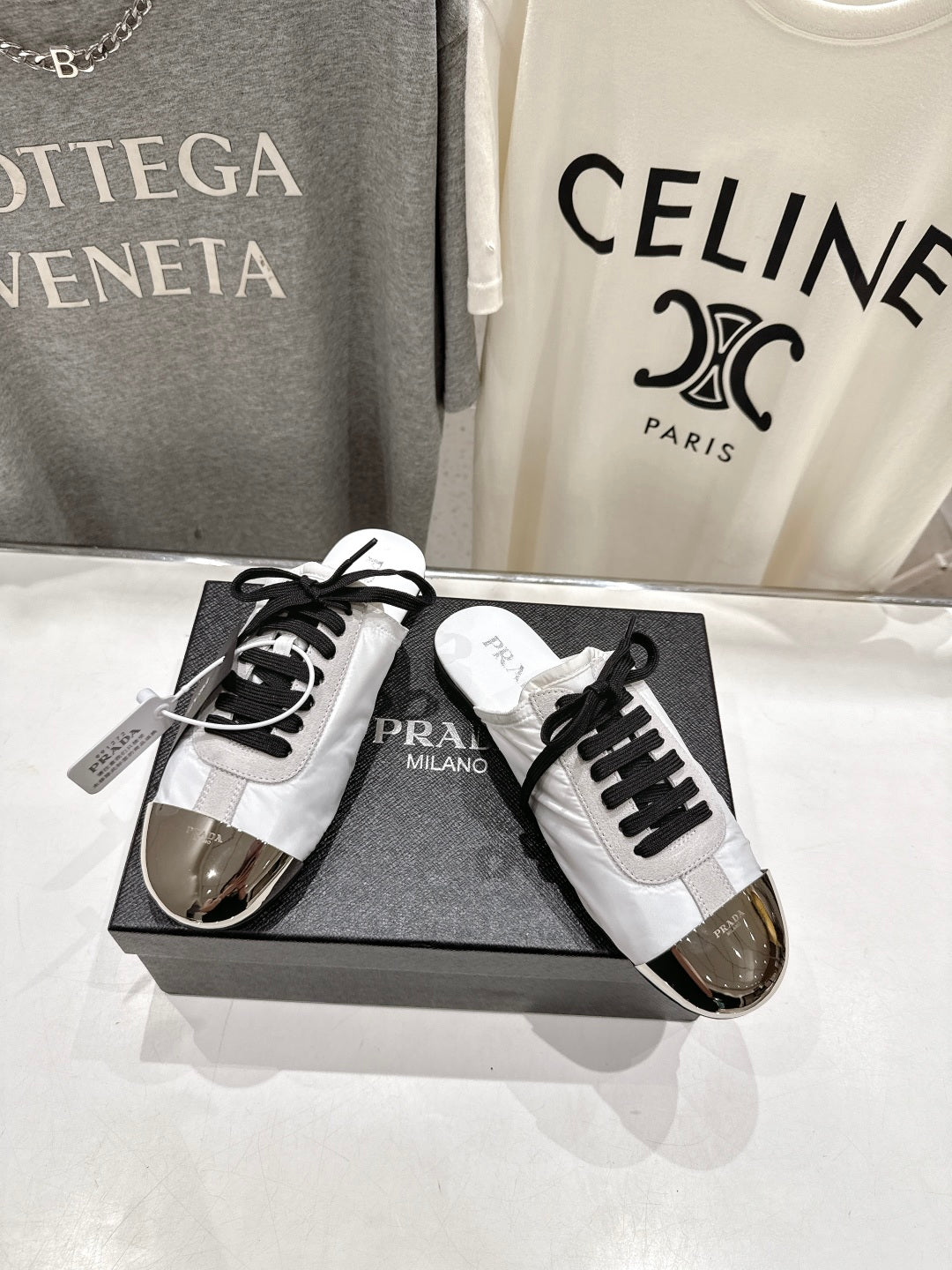 PRADA 25S MULES IN WHITE WITH METAL TOECAP