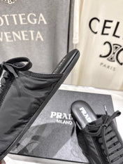PRADA 25S MULES IN BLACK WITH METAL TOECAP