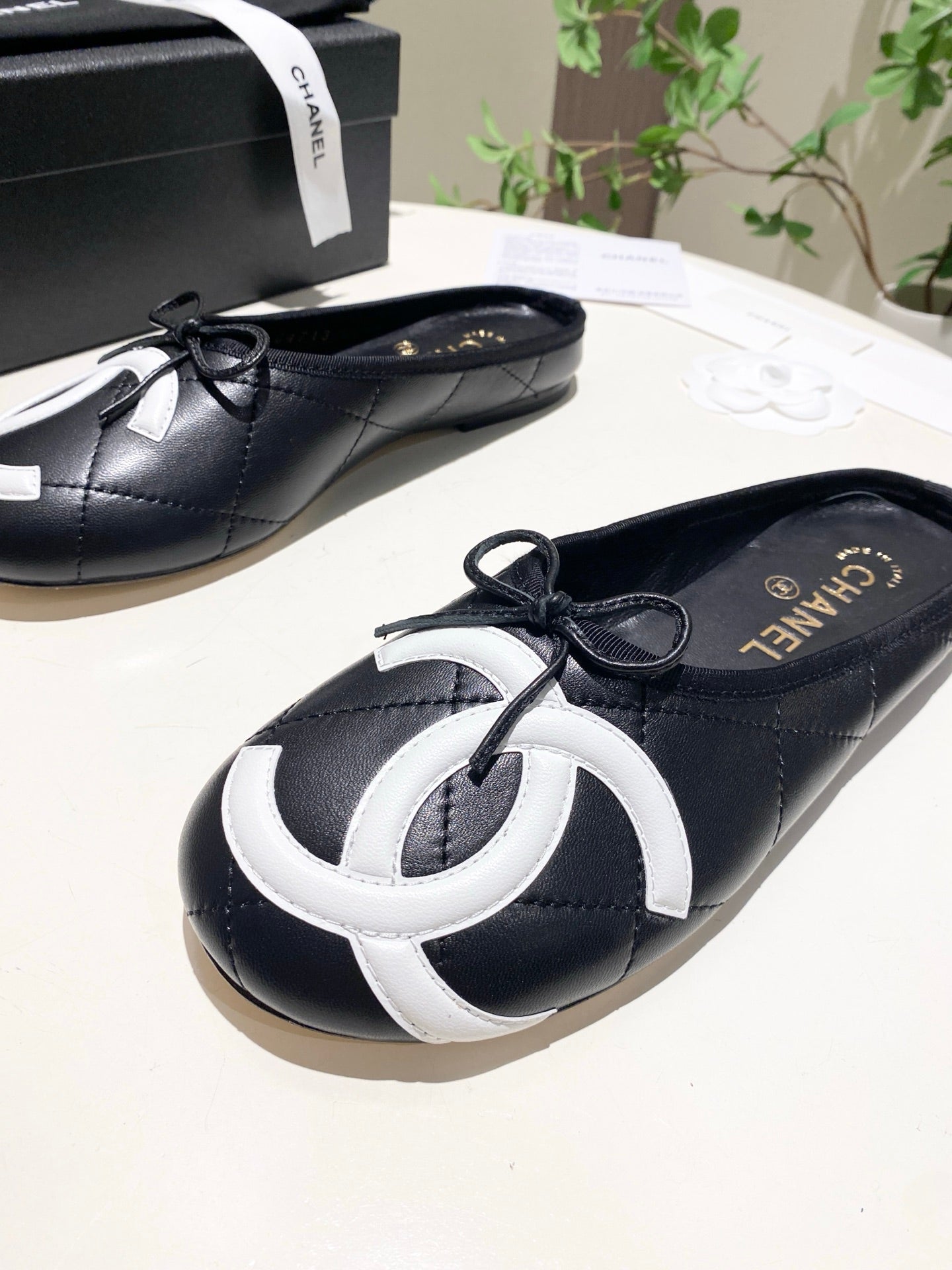 CHANEL 26S FLAT MULES IN BLACK LAMBSKIN