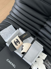 WOVEN SLIDE IN RAFFIA AND BLACK LAMBSKIN