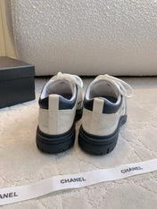 CHANEL 25S TRAINERS 40MM IN WHITE AND BLACK CALFSKIN