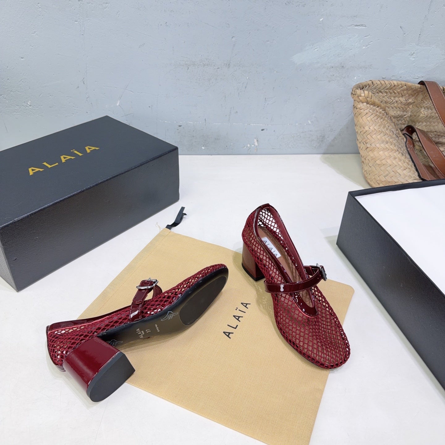 ALAIA 26S HIGH-HEEL MARY JANES 50 MM IN DARK RED WOVEN MESH