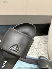 PRADA 25S PADDED SLIDES IN BLACK CALFSKIN WITH LOGO
