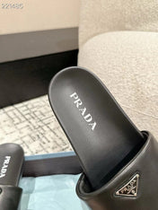 PRADA 25S PADDED SLIDES IN BLACK CALFSKIN WITH LOGO