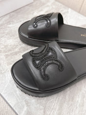 THICK-SOLED SLIDES IN BLACK SMOOTH LAMBSKIN LOGO WITH CRYSTALS