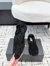 ALAIA 26S FLAT SLIP-ONS IN BLACK SUEDE WITH OPENWORK PATTERN
