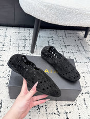 ALAIA 26S FLAT SLIP-ONS IN BLACK SUEDE WITH OPENWORK PATTERN