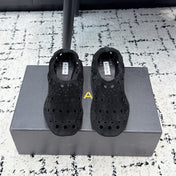 ALAIA 26S FLAT SLIP-ONS IN BLACK SUEDE WITH OPENWORK PATTERN