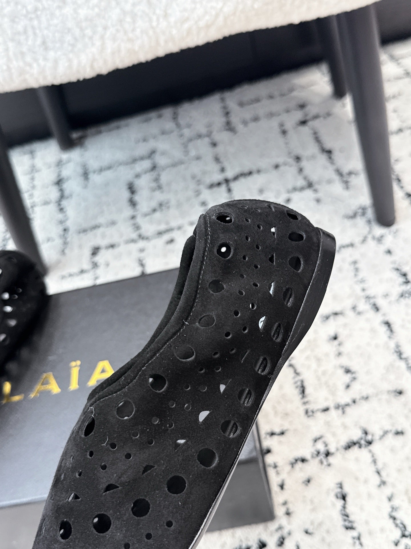 ALAIA 26S FLAT SLIP-ONS IN BLACK SUEDE WITH OPENWORK PATTERN