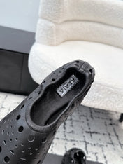 ALAIA 26S FLAT SLIP-ONS IN BLACK CALFSKIN WITH OPENWORK PATTERN