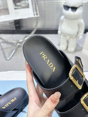 PRADA 25S STRAP SLIDES 30MM IN BLACK CALFSKIN GOLD HARDWARE