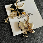 CHANEL 26S DOUBLE C LOGO BLACK ENAMEL BOW DANGLE EARRINGS WITH CHAIN CHARMS IN GOLD METAL 629178