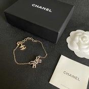 CHANEL 26S CRYSTAL BOW CHAIN BRACELET IN GOLD METAL 629980