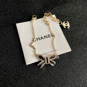 CHANEL 26S CRYSTAL BOW CHAIN BRACELET IN GOLD METAL 629980