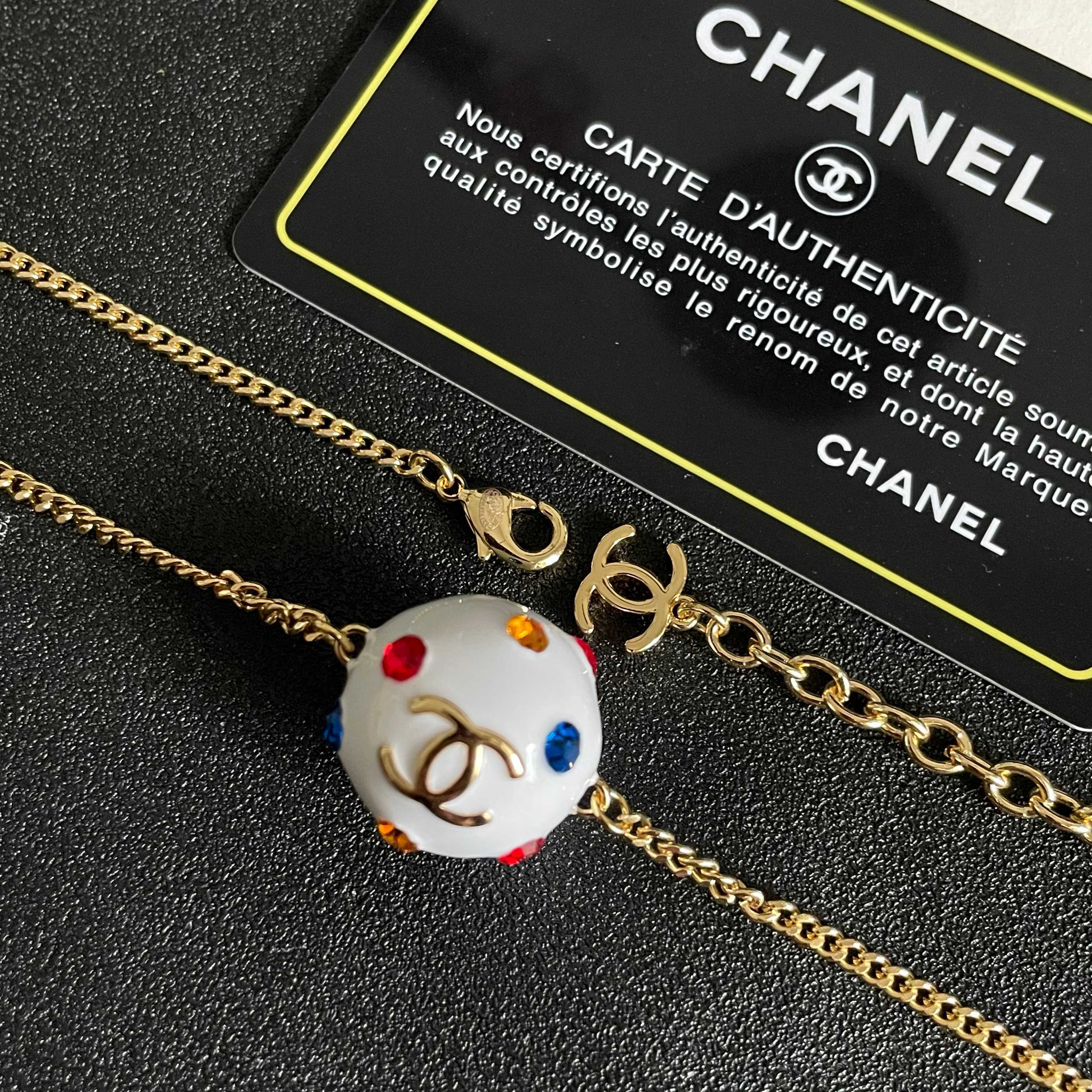 CHANEL 26S DOUBLE C LOGO WHITE ENAMEL CRYSTAL BALL PENDANT NECKLACE IN GOLD METAL 629889