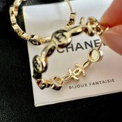 CHANEL 26S DOUBLE C LOGO BLACK ENAMEL & CRYSTAL LINK HOOP EARRINGS IN GOLD METAL 629897