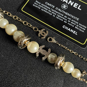 CHANEL 26S DOUBLE C LOGO PEARL BEADED BRACELET WITH CRYSTAL DETAIL IN GOLD METAL 631014