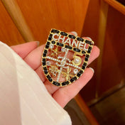CHANEL 26S NUMBER SHIELD BROOCH WITH MULTI-CRYSTAL DETAIL IN GOLD METAL 631042