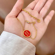 MIUMIU 26S LOGO ROUND BRACELET IN RED ENAMEL AND GOLD TONE METAL 631810