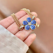 CHANEL 26S DOUBLE C LOGO BLUE ENAMEL FLOWER CHAIN BRACELET WITH CRYSTAL DETAIL IN GOLD METAL 633154