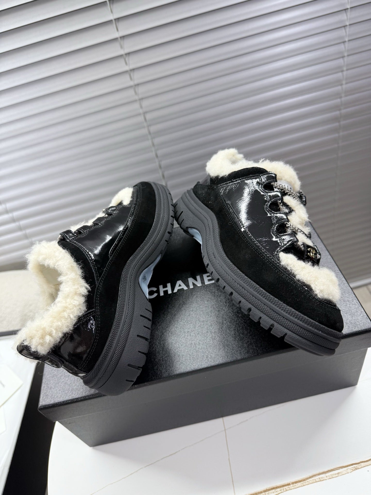 CHANEL 25S SNEAKERS WITH FUR ACCENTS 35MM IN BLACK CALFSKIN
