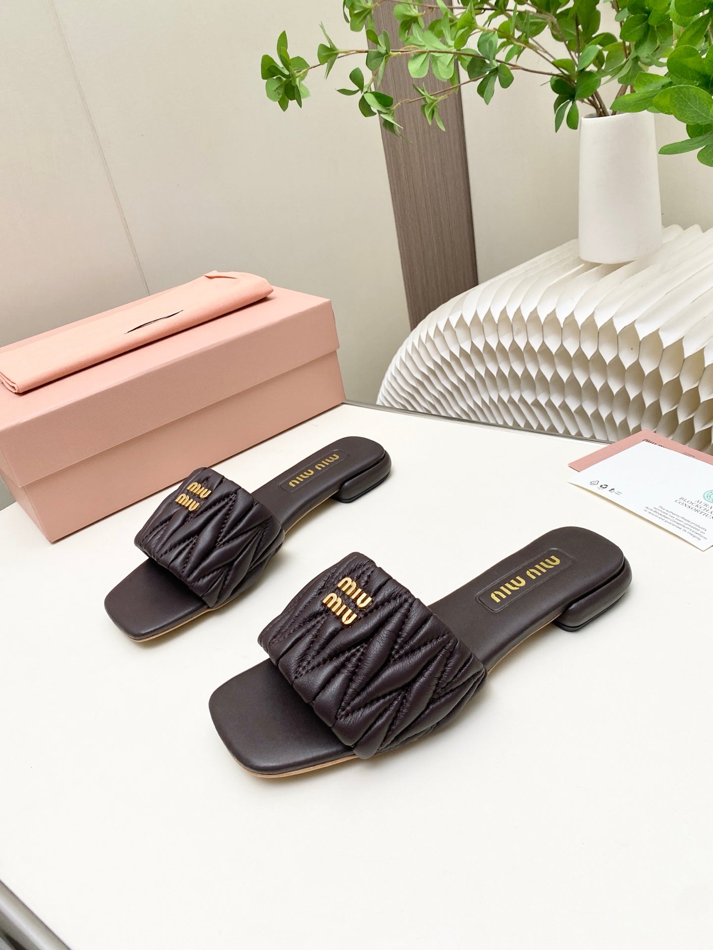 MIUMIU 26S MATELASSE SLIDES IN DARK BROWN CALFSKIN